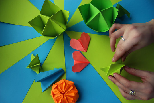 Multicolored Origami on a bright striped table