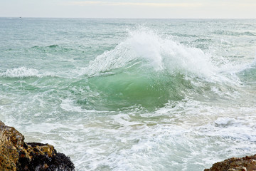sea wave off a rocky coast