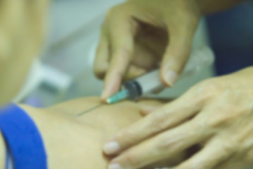 Blurry background, Nurse collecting a blood from a patient