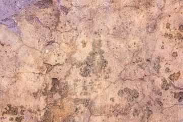 The surface of the old plaster pink wall. Many cracks and damage.