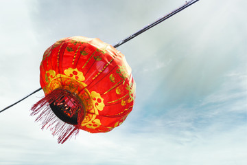 Obraz premium Chinese red lamp against blue sky with sunny clouds