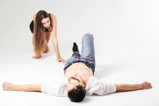 Pretty girl crawls to bearded man lying on floor