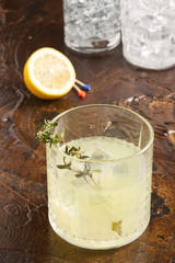 Vodka lemon glass on the brown surface.