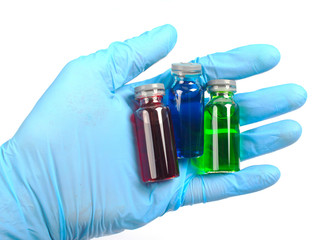 vial with a vaccine or cure for holding a blue gloves