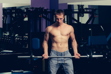 handsome sexy man has muscular body training with barbell