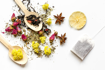 Wooden spoons with herbal tea white background top view mock-up