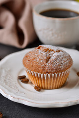 Vanilla muffins with fresh coffee for breakfast on a black background