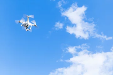 Fotobehang Quadrocopter, compact drone in cloudy sky © evannovostro