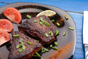 fried steak on a wooden table