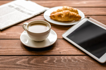 Businessman lunch at home with coffee, croisant and device