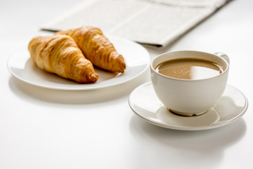 Breakfast for businessman with coffee and croissant on white table