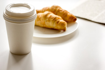 Breakfast for businessman with coffee and croissant on white table