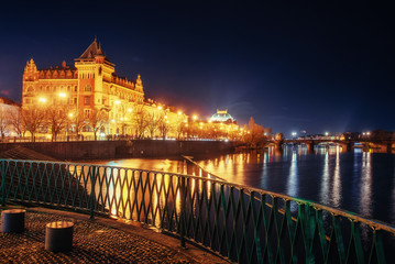Fototapeta na wymiar The magnificent Prague Castle at night along the River Vltava.