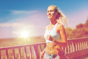 smiling young woman running outdoors