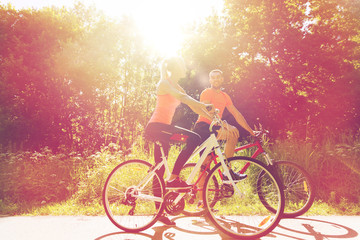 Fototapeta na wymiar happy couple riding bicycle outdoors