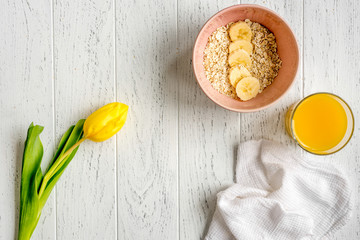 healthy breakfast with porridge on wooden background top view