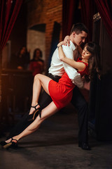 Dancing young couple on a white background. Passionate salsa.