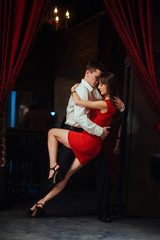 Dancing young couple on a white background. Passionate salsa dan