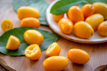kumquat on plate at wooden table