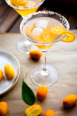 cocktail with kumquat on wooden background