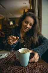 Young girl drinking coffee in a cafe.