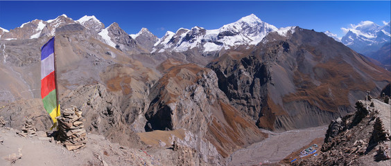 Mountain view from High Camp towards Throng Phedi Base Camp on the trekking trail to Thorong La Pass, Annapurna Circuit, Conservation area, Himalayas, Nepal, Asia. Horizontal panorama.