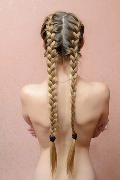 blonde girl with the naked back and long hair braided