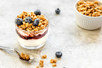 Healthy breakfast from yoghurt with muesli and berries on kitchen table