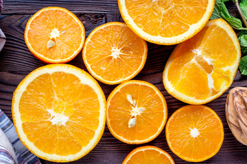 orange juice with mint squeezing on wooden kitchen background top view