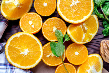 Orange juice making from fruit and mint on kitchen table top view