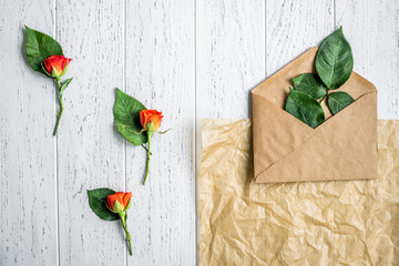 envelope and flowers on wooden background top view mock up