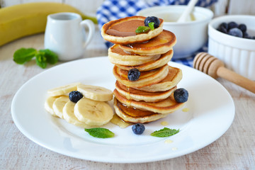 Pancakes for breakfast with honey and blueberries 
