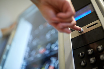 hand pushing button on vending machine