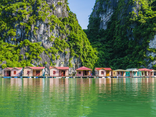 Floating fishing village reflected in emerald waters of Ha Long bay, Vietnam   © SimoneGilioli