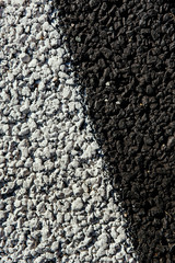 Asphalt road black with white markings. macro shooting