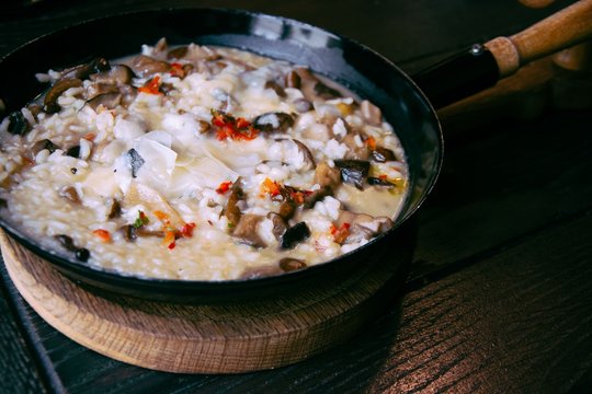 Risotto with mushrooms in cooking pan. Healthy vegetarian meal.