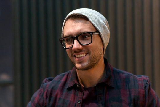 happy smiling man in eyeglasses and hipster hat