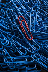 Red Paper Clip Standing out from the crowd with color
