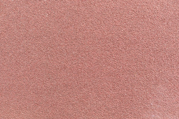 Close view of maroon sandpaper.