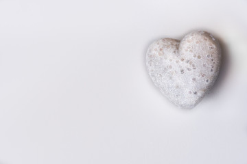 Obraz premium Single White Glitter Heart on a White Background