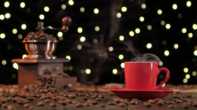 Red cup of hot coffee with smoke. Background with lights