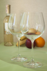 wine glasses empty and the fruit on the tablе