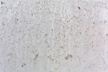 Cracked smooth surface of concrete close view.