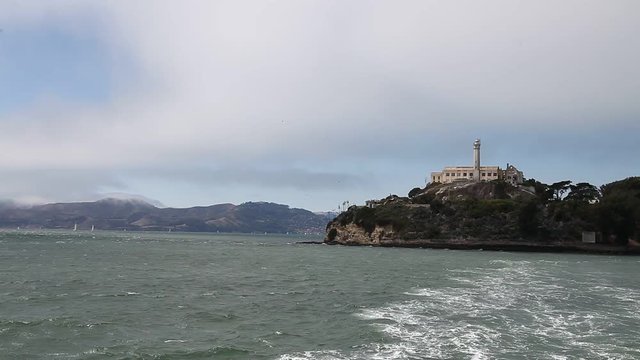Alcatraz island prison of San Francisco. Sea view panorama by ferry. Warden's house and lighthouse. Escape and freedom concep. Traveling in California. Popular tourist attraction in San Francisco.