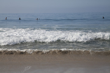 Heavy, foamy waves lapping at the ocean shore