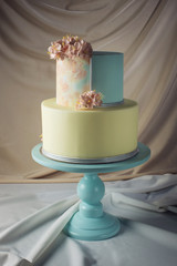 Artwork. Wedding cake decorated in pastel style with pink flowers