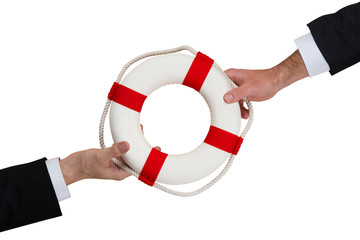 Businessmen Passing Lifebuoy Over Wooden Table