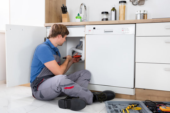 Male Plumber Fixing Sink Pipe