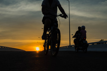 Fototapeta na wymiar Silhouette of a bike on sky background on sunset