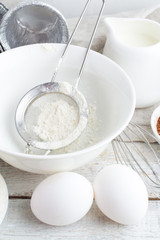 Fototapeta na wymiar bowl with flour, eggs, cocoa and milk